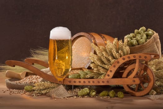 Beer glass with barrel,wheelbarrow,wheat,barley,hops and malt