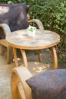 Table and chairs standing in the garden with shadows, stock photo