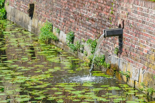 Moat,moat with rainwater inlet around an old castle.
