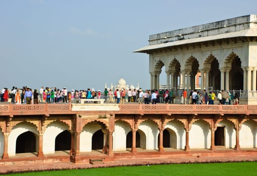 Crowded visitors looking Taj Mahal from view of Agra fort, India