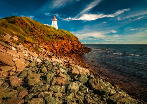 Eroded beach cliff and lighthouse Prince Edward Island Canada
