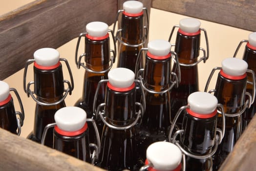 Close-up of many beer bottles with ironing closure in old beer box