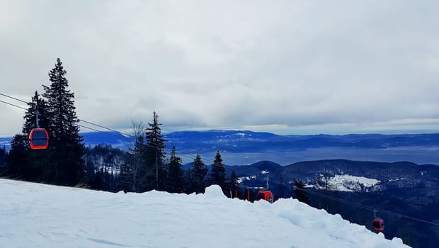Cable car on the ski resort. Beautiful winter landscape in Carpathian Mountains, Brasov, Romania