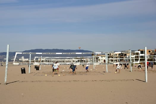 Long Beach,United States - December 26,2015: Volleyball players play volleyball on a beach volleyball court on Long Beach beach on December 26,2015 in Long Beach.