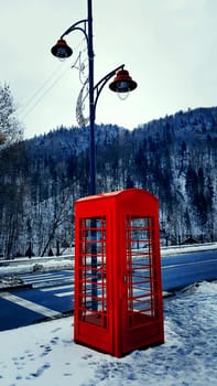 Vintage, red phone cabine. Touristic attraction on the street in Sinaia, Romania