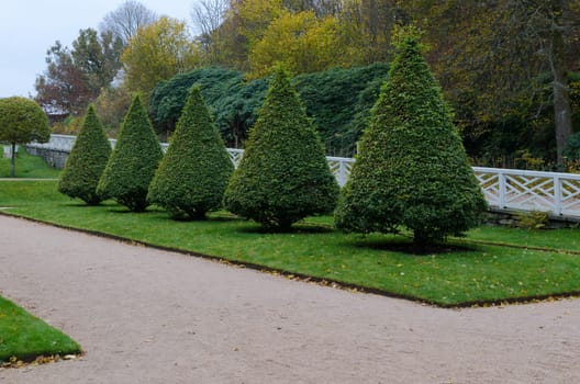 Garden in Gunnebo castle with small tree on the grass
