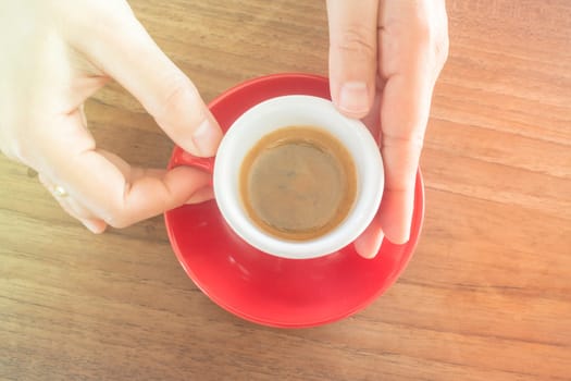 Hands holding cup of hot coffee, stock photo