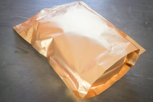 Golden aluminum bag of premium coffee bean, stock photo