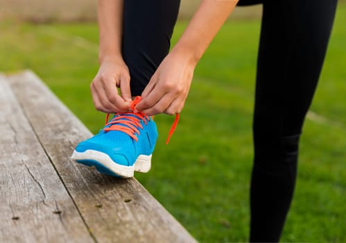 Woman tying her shoes and getting ready for train