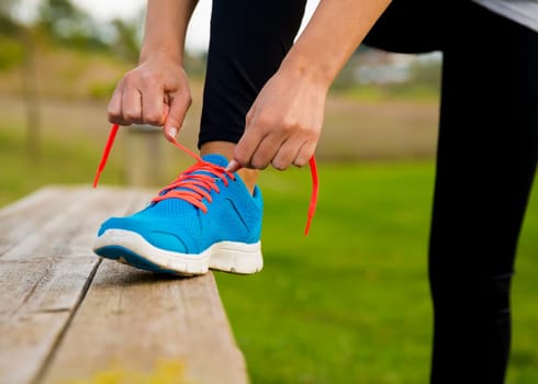 Woman tying her shoes and getting ready for train