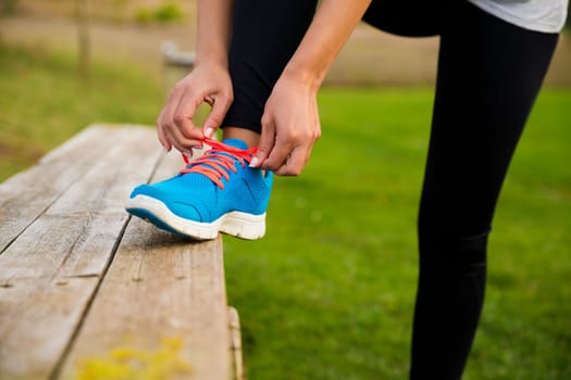 Woman tying her shoes and getting ready for train