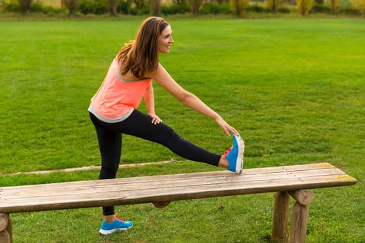 Beautiful woman stretching her muscles after finish the workout