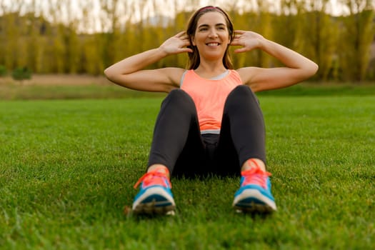 An attractive woman exercising outdoor on a soccer field