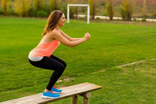 An attractive woman exercising outdoor on a soccer field