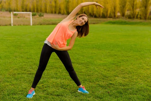 Beautiful woman stretching her muscles after finish the workout