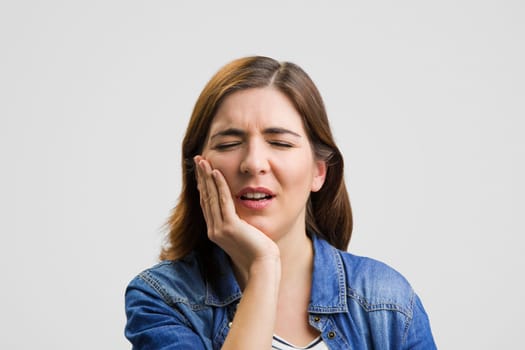 Frustrated woman in pain with a sore throat