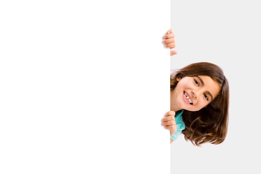 Young girl holding and showing something on a whiteboard