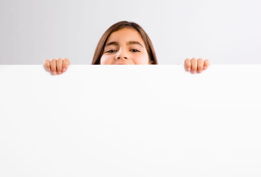 Young girl holding and showing something on a whiteboard