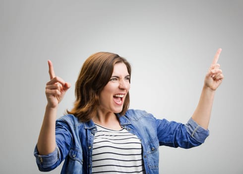 Studio portrait of a successful woman with arms raised