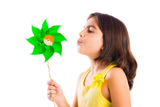 Beautiful girl blowing a plastic windmill