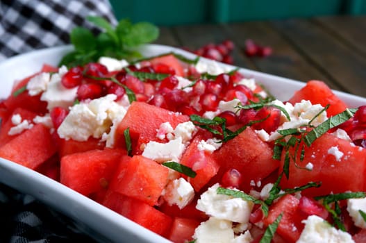 Watermelon with feta cheese and pomegranate seeds