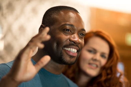 Young man waving to someone in a bar