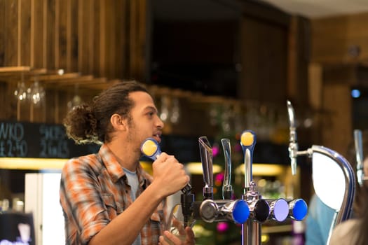 bartender pulling pints in a pub