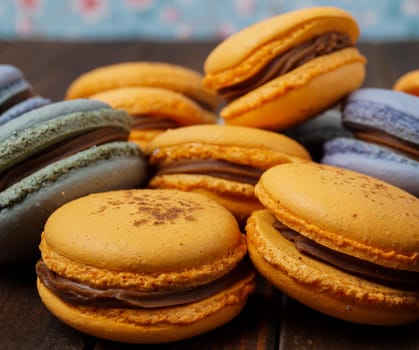 pile of delicious blue and orange macaroons with ganache filling