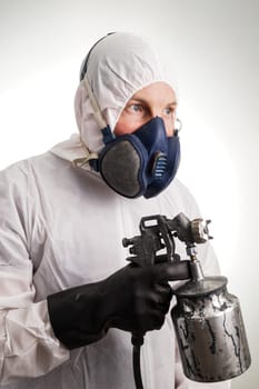 Man in protective suit, gloves, paintpistol and a respiraton