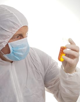 Man testing lab sample in protective suit and mask