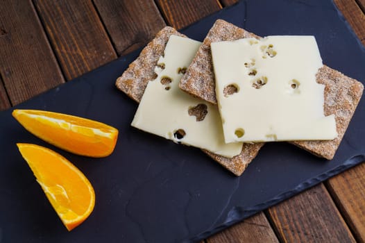 Crispy rye bread with cheese and orange
