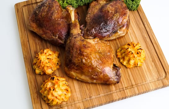 crispy duck leg served with baked potatoes