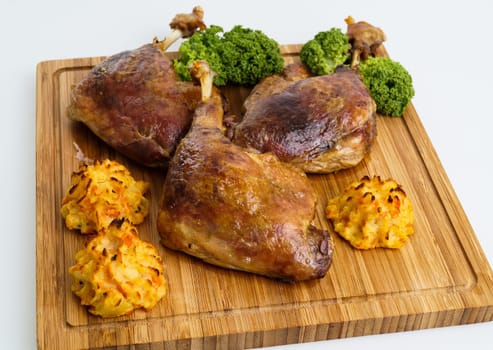 crispy duck leg served with baked potatoes