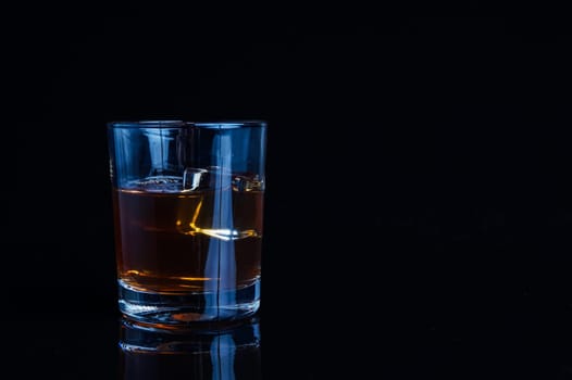 A glass of whisky or rum, with green backlight