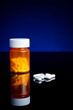 medicin, tablets and pillbottle, with blue background