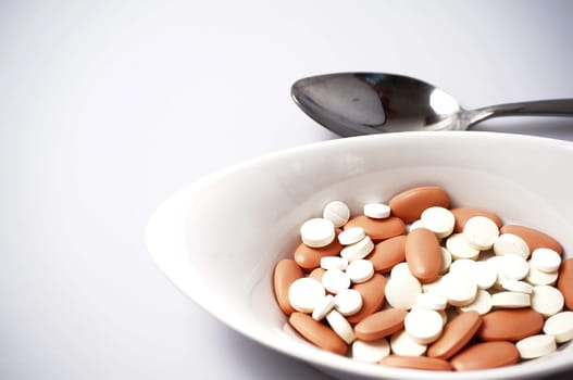 prescription drugs in a bowl whit a spoon