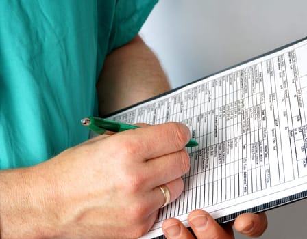 nurse or Doctor writting on the medical chart