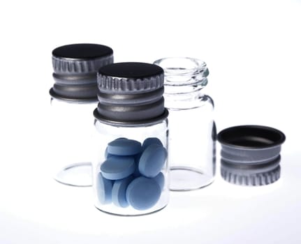 Medicine in clear bottle on white background
