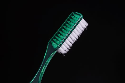 Green Toothbrush isolated on Black with cope space