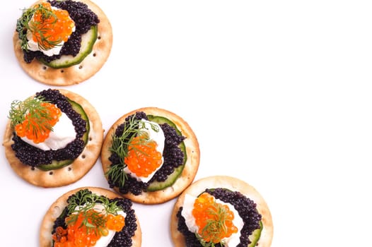 Caviar Appetizer served on crackers isolated on white