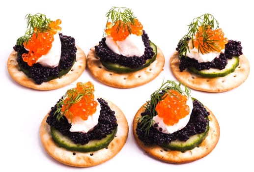 Caviar Appetizer served on crackers isolated on white