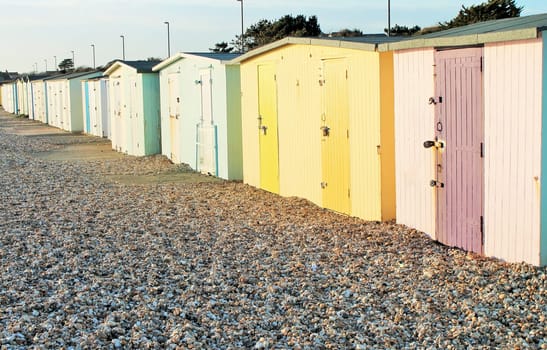 Traditional British beach huts at Uk seaside Brightly coloured beach huts on the front at Bognor Regis, Sussex, England