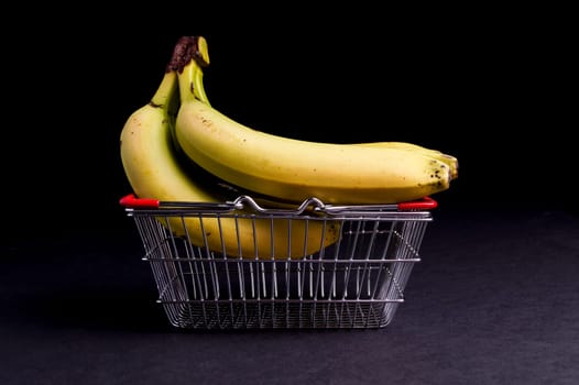Basket of Ripe Organic Bananas isolated on Black
