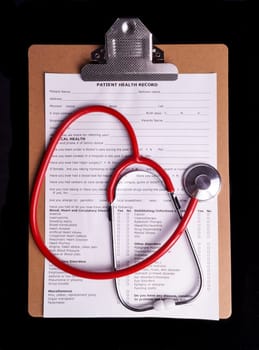 Medical Chart and stethoscope isolated on black background