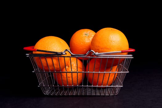 Basket of Organic ripe Orange ioslated on Black