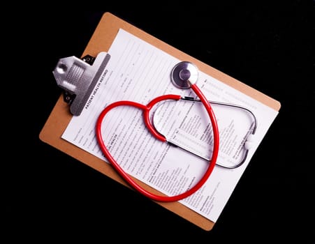 Medical Chart and stethoscope isolated on black background