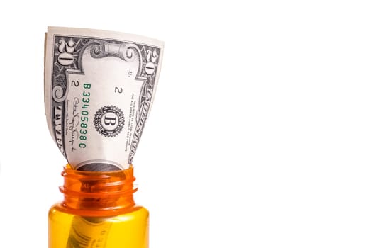 Money in a prescription Medicin Bottle. Both Prescription and Drugs cost a lot of money