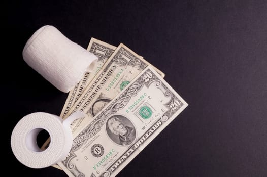 Therapeutic self adhesive tape for, aches and tension lying with money, isolated on Black