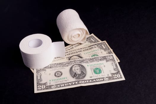 Therapeutic self adhesive tape for, aches and tension lying with money, isolated on Black
