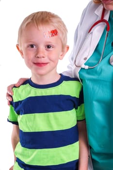 Child gets injury on the forehead and the nurse helps with getting plaster on the wound so it can heal
